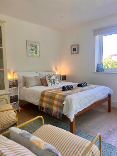 a bedroom with two beds and a window at The lighthouse in St Ives