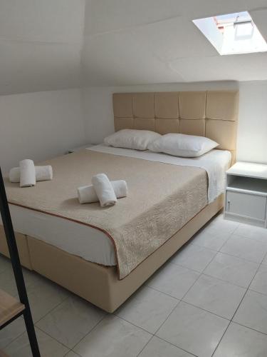 a bedroom with a bed with two towels on it at Apartments Gregory & George in Hanioti