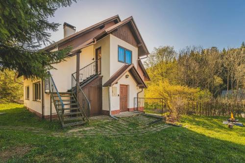 a house with a staircase in a yard at Orličky Apartments in Orličky