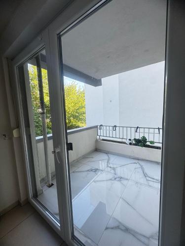 an empty room with a glass door and a balcony at Das gemütliche Unterkunft in Gelsenkirchen