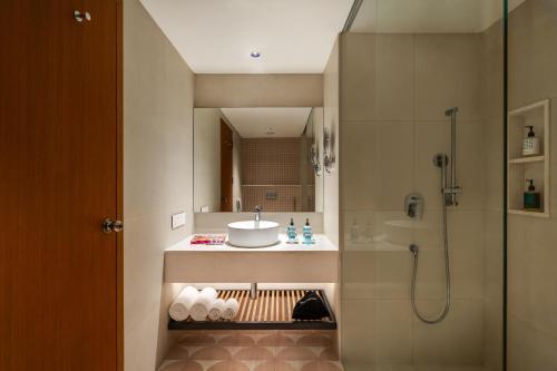 a bathroom with a sink and a shower at Greenpark Chennai in Chennai