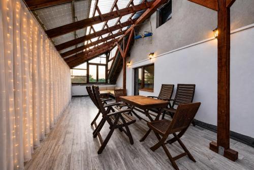 a dining room with a wooden table and chairs at Apartament pod gruszą in Legbąd