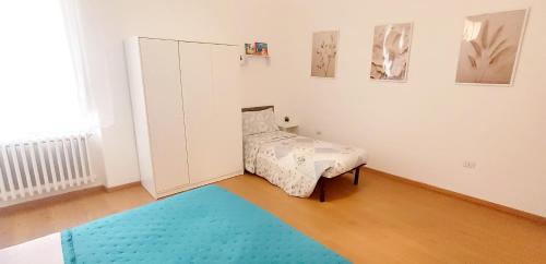 a room with a bed and a blue rug at Civico 16 in Sulmona