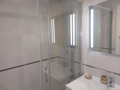 a white bathroom with a shower and a sink at Luc61 - Vistas al mar in La Estación