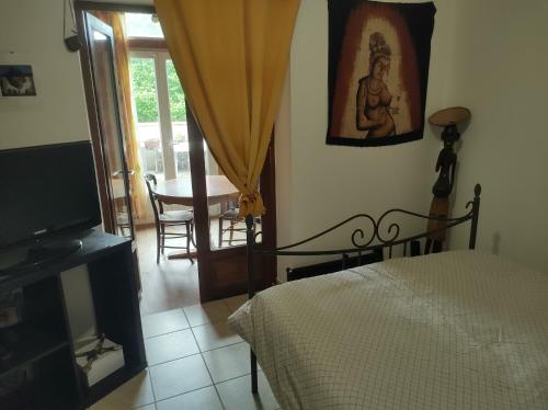 a bedroom with a bed and a television and a table at Fab's Home in Oust