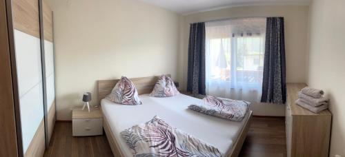 a bedroom with a bed with pillows and a window at Appartement Stichauner in Tschöran