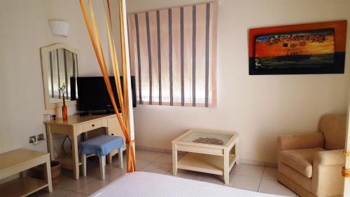 a bedroom with a bed and a desk and a chair at Sea Sight Boutique Hotel in Porto Rafti