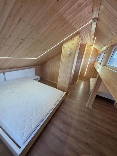 a small room with a bed in a sauna at D&A Vila - Private Villa with Sauna & Hot Tub in Arciūnai