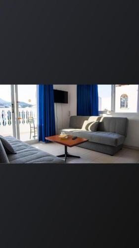 a living room with a couch and a coffee table at Atlantis Apart Hotel in Marmaris