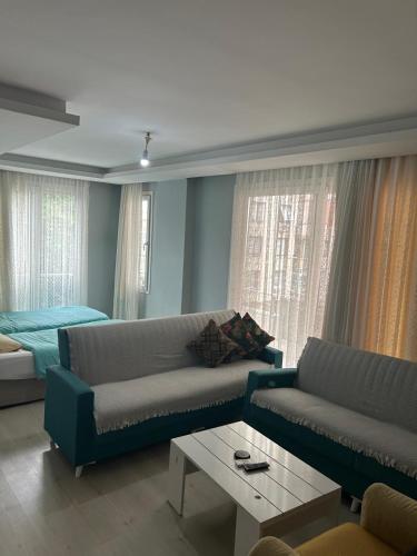 a living room with a couch and a bed at Premium Life Apart in Kapuluören
