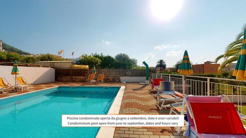 a swimming pool with chairs and umbrellas at CliVio - By Ligooria in Pietra Ligure