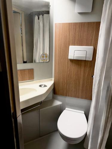 a small bathroom with a toilet and a sink at Première Classe Tarbes - Bastillac in Tarbes