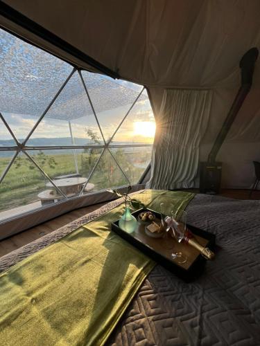 a bed in a tent with a tray of food at Glamping-Steiermark in Pöllauberg