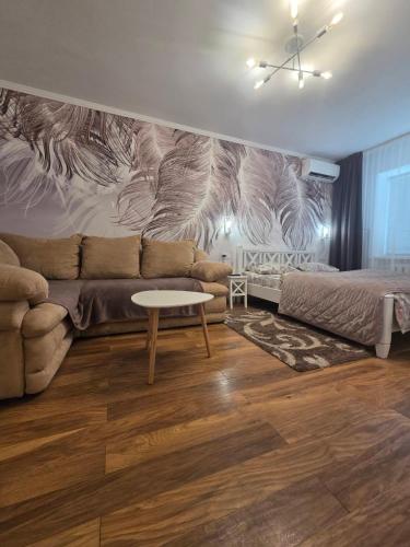 a living room with a couch and a table at Апартаменты в центре in Chernihiv