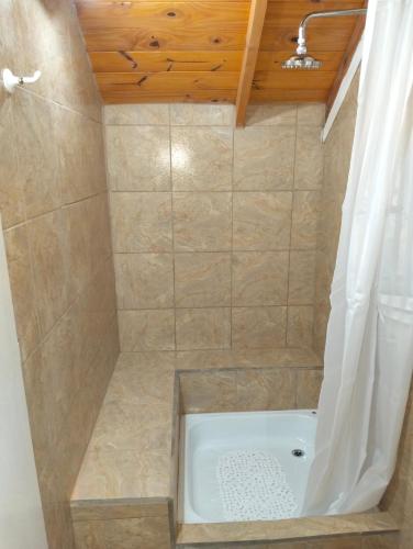 a bathroom with a bath tub with a shower curtain at Hosteria Atelier in Tigre
