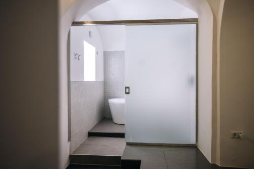 a bathroom with a white toilet and a sink at 4 Rooms in Maribor