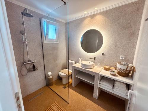 a bathroom with a sink and a shower at Almyra Suites in Archangelos