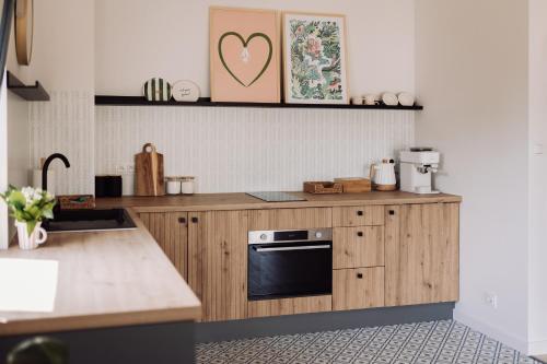 a kitchen with a wooden counter top with a stove at Apartamenty Wrzosowa 23 z garażem na rowery in Kudowa-Zdrój