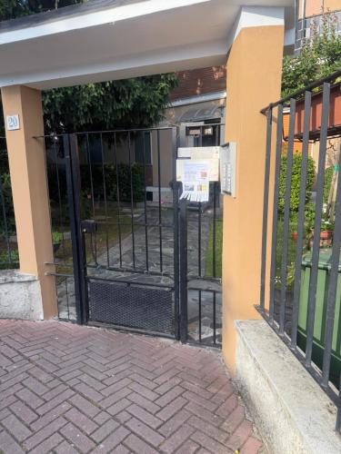 an entrance to a building with an open gate at Sky Balcony - Milano Sud- vicino Humanitas e forum Assago in Rozzano
