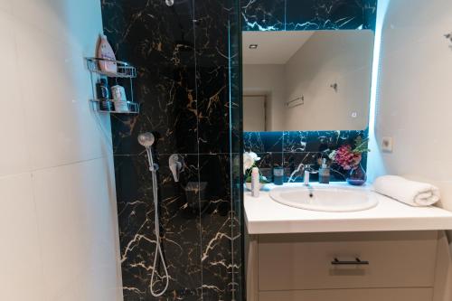 a bathroom with a sink and a mirror at Unique Kos Apartment in Ampavris