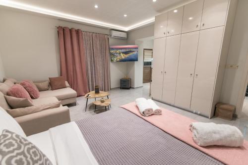 a living room with a bed and a couch at Unique Kos Apartment in Ampavris
