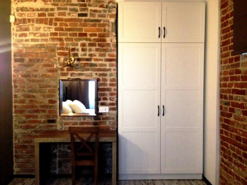 a room with white cabinets and a brick wall at Potocki Apartments in Lviv