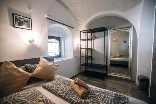 a bedroom with a bed and a mirror in a room at 4 Rooms in Maribor