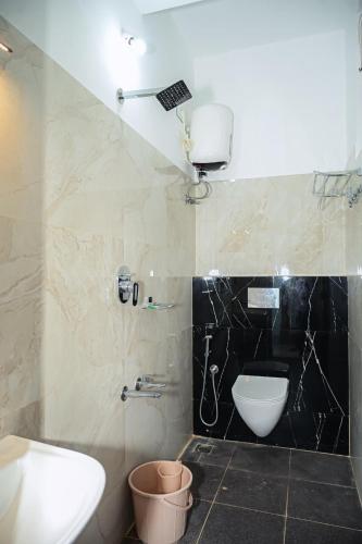 a bathroom with a sink and a toilet in it at Coorg Manam Homestay in Kushālnagar