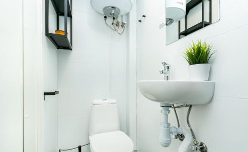 a bathroom with a sink and a toilet at Sõle Studios by RevalHome in Tallinn