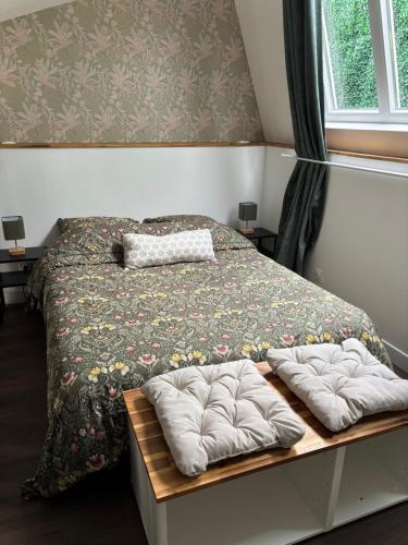 a bedroom with a bed with two pillows on it at L atelier de Jules in Lyon