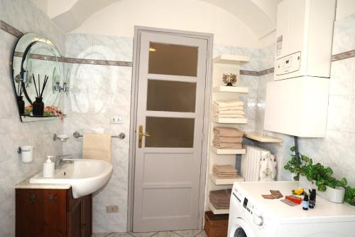 a bathroom with a sink and a white door at Teddy Bear trilocale, family, centro Biella in Biella