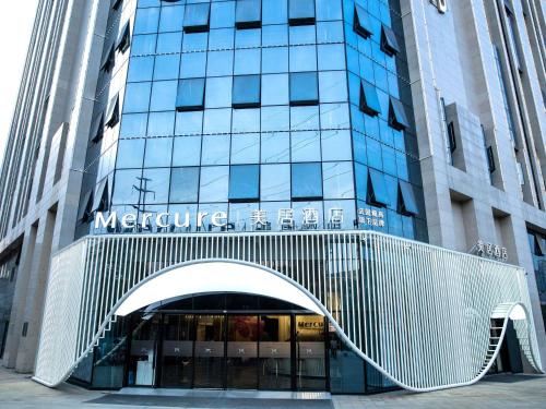 a building with a sign on the front of it at Mercure Chengdu Xindu in Chengdu