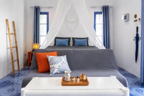 a bedroom with a bed with a white canopy at Archie Village in Hinkong