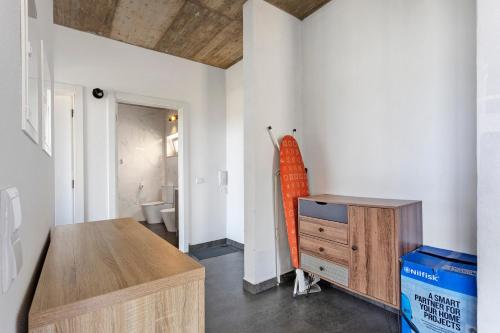 a room with a table and a dresser in it at Colina do Sol 2 in Amoreira