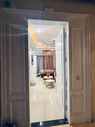 an open door to a room with a living room at Saffron Nest in Zirakpur