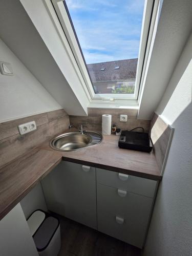 a bathroom with a sink and a skylight at Ferienwohnung Bruhn in Meldorf