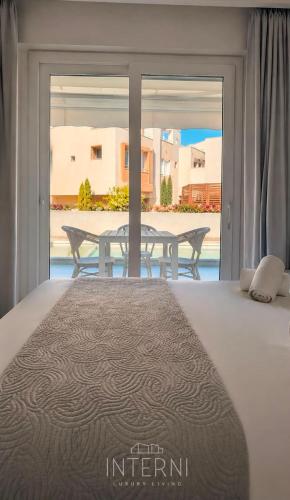 a bedroom with a bed and a table with a view at INTERNI LUXURY LIVING b in Nikiti