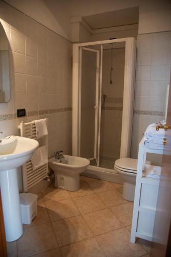 a bathroom with a shower and a toilet and a sink at Villa Govi in Diano Castello
