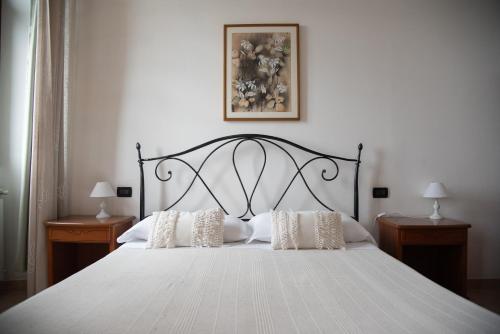 a bedroom with a large white bed with pillows at Villa Govi in Diano Castello