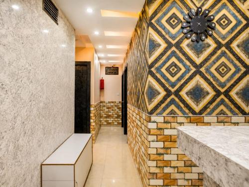 a hallway with a wall with a clock on it at Saba Guest House in Kolkata
