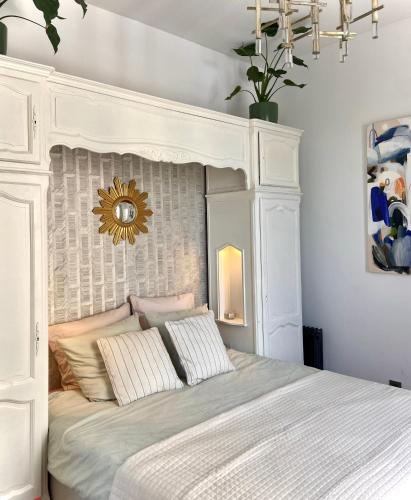 a bedroom with a bed with a white headboard at La Cathédrale in Soissons