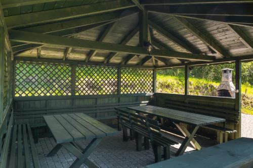 a picnic table and benches in a pavilion at Willa Tęcza in Szczawnica