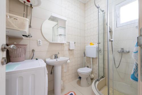 a bathroom with a toilet and a sink and a shower at Apartments Gabi&Zdenka Tivat in Tivat