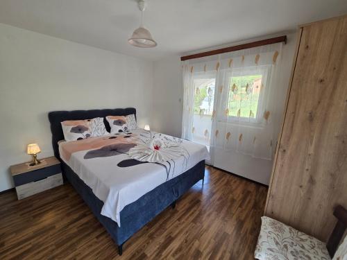a bedroom with a bed with a flower on it at Apartments Drita in Baška
