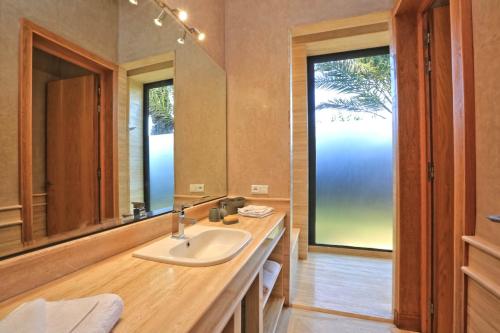 a bathroom with a sink and a large mirror at Luxury Marrakech Villa marrakech pool,staff,brekfast included in Marrakesh