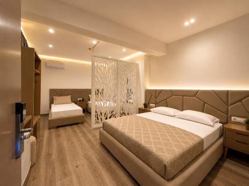 a bedroom with a large bed and a television at Hotel Mare 2 in Ksamil
