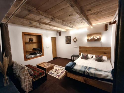 a bedroom with a bed and a couch in a room at Tiny house soyal in Kulu