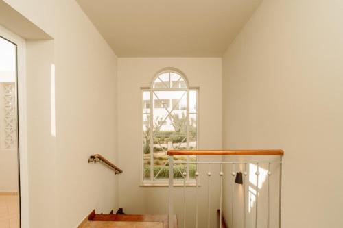 a room with white walls and a window at Vale d'El Rei Hotel & Villas in Carvoeiro