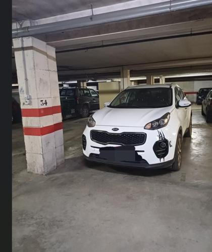 a white car parked in a parking garage at Loft A la verita River,PARKING PRIVADO GRATIS in Córdoba