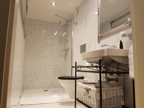 a bathroom with a sink and a toilet and a shower at Charles apartment in Prague